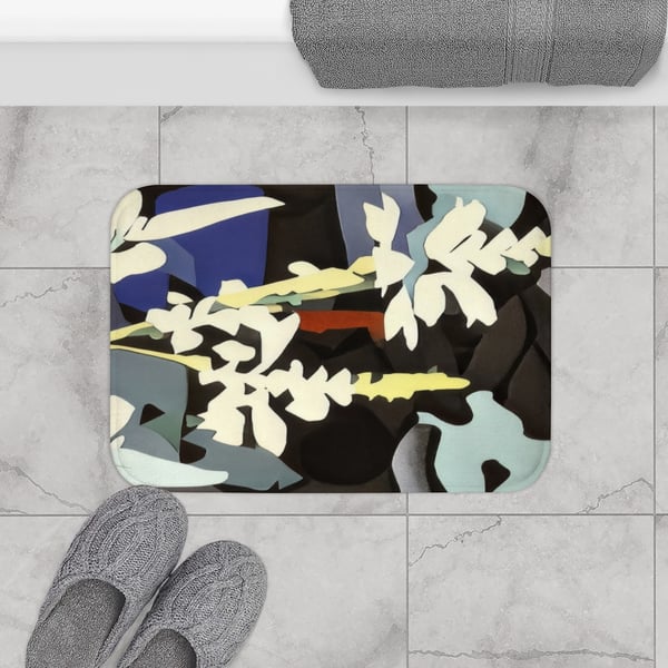 A digital artwork depicting abstract floral patterns in cool tones adorns this practical and stylish microfiber bath mat with anti-slip backing, shown on a tiled bathroom floor next to cozy slippers.