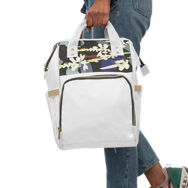 Digital artwork depicting a person in denim pants holding a multifunctional diaper backpack. The backpack features a floral design on a camouflage background, a spacious main compartment with a zipper, elastic and net pockets for organization, padded back panel, and adjustable shoulder straps, all depicted in high-grade nylon with a cream interior lining.